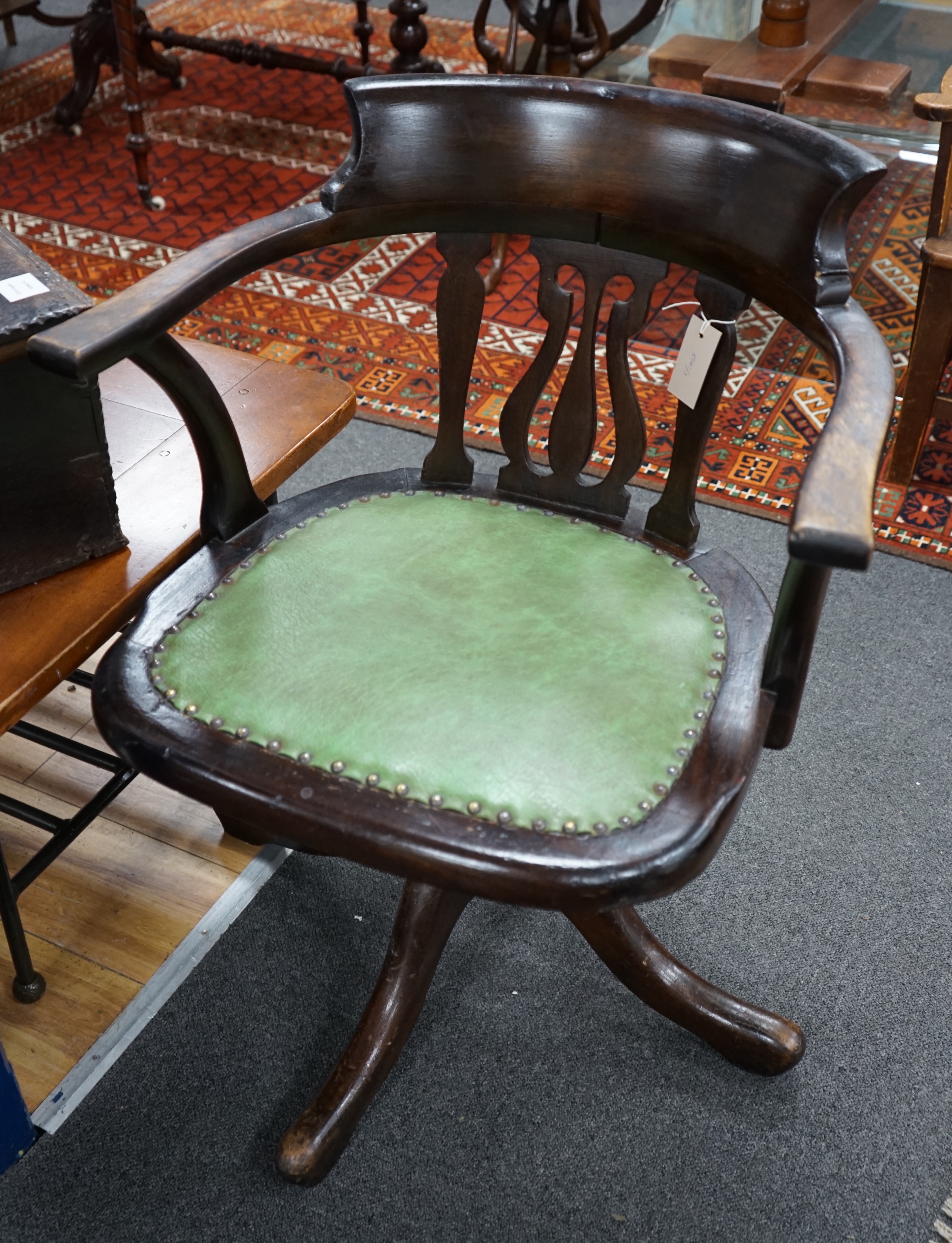 An Edwardian beech revolving office elbow chair